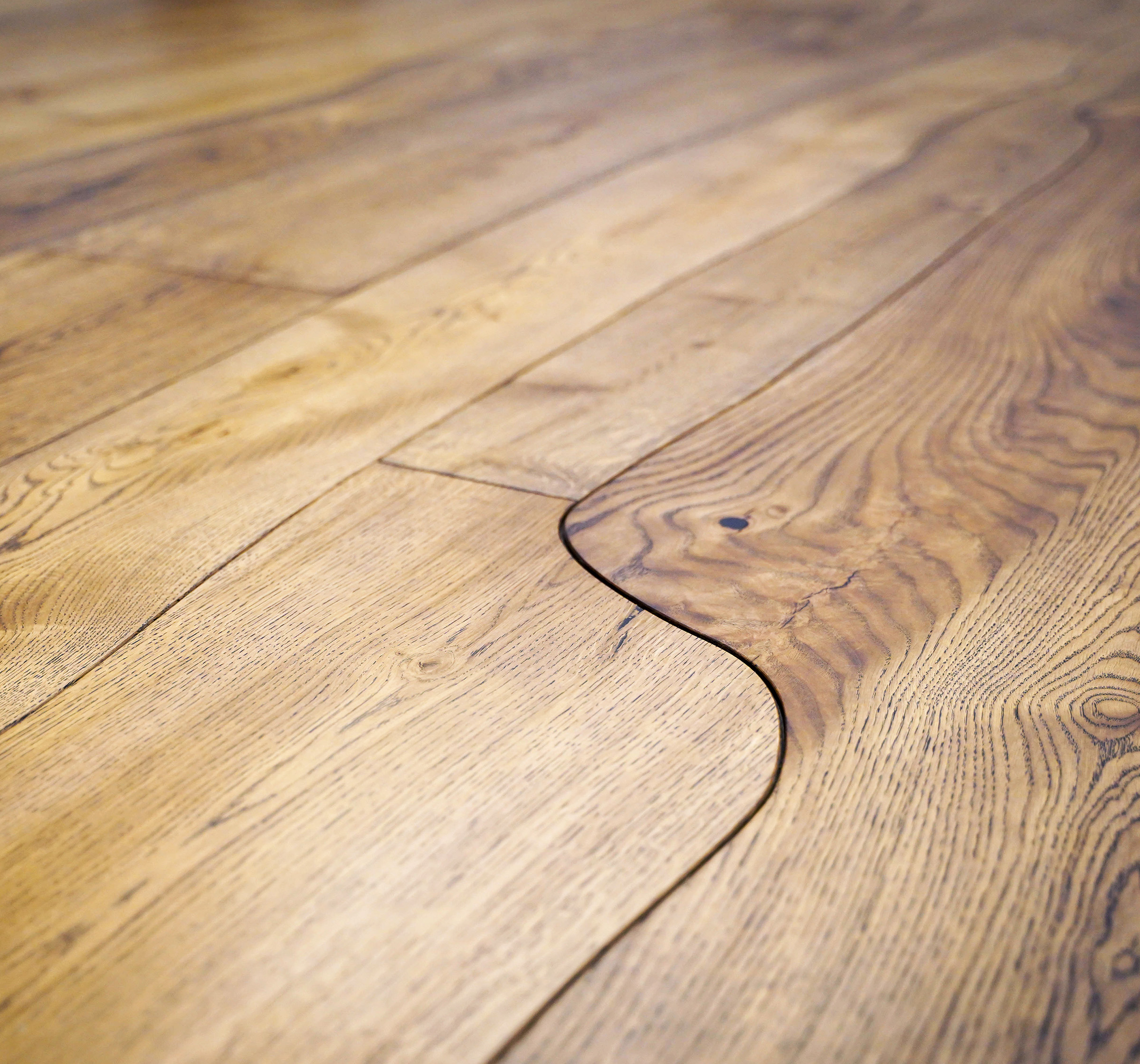 Exquisite curved wood flooring aka Bole floor, with wild, unique, and natural shapes in Rustic style